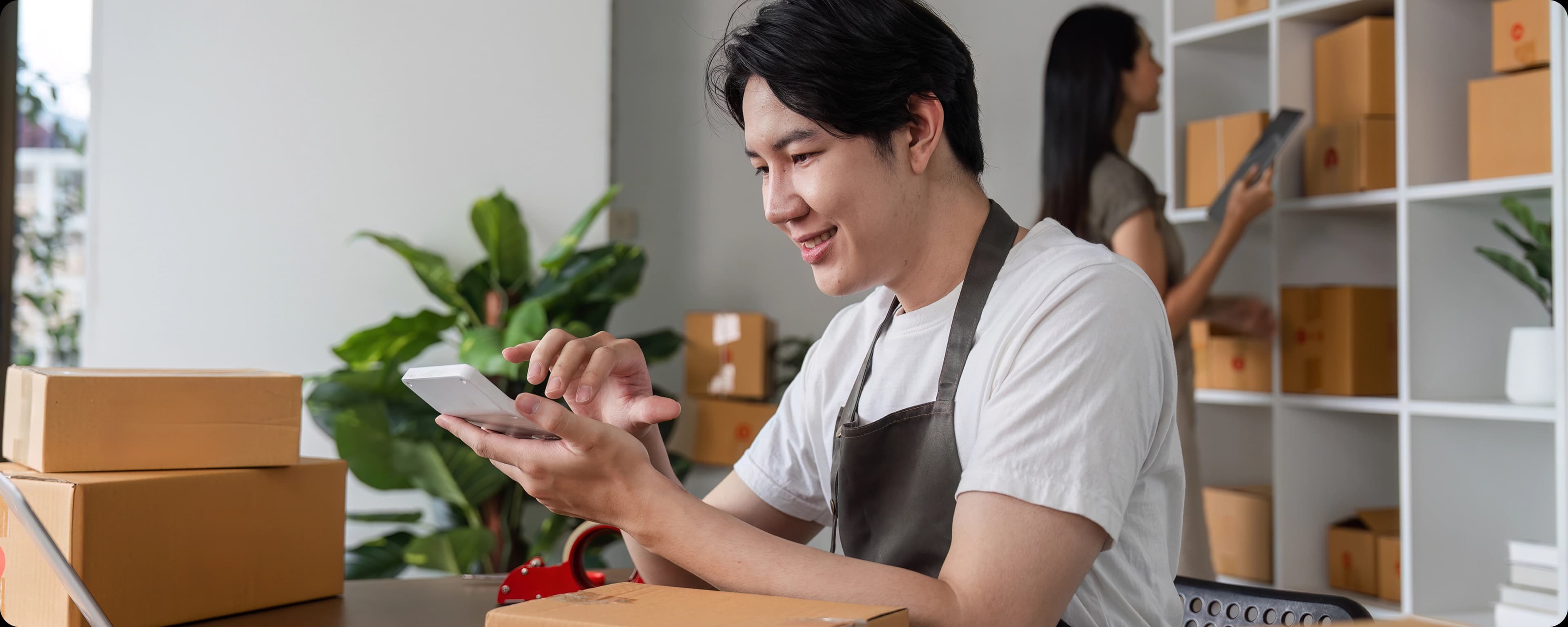 Man in apron using laptop touchpad