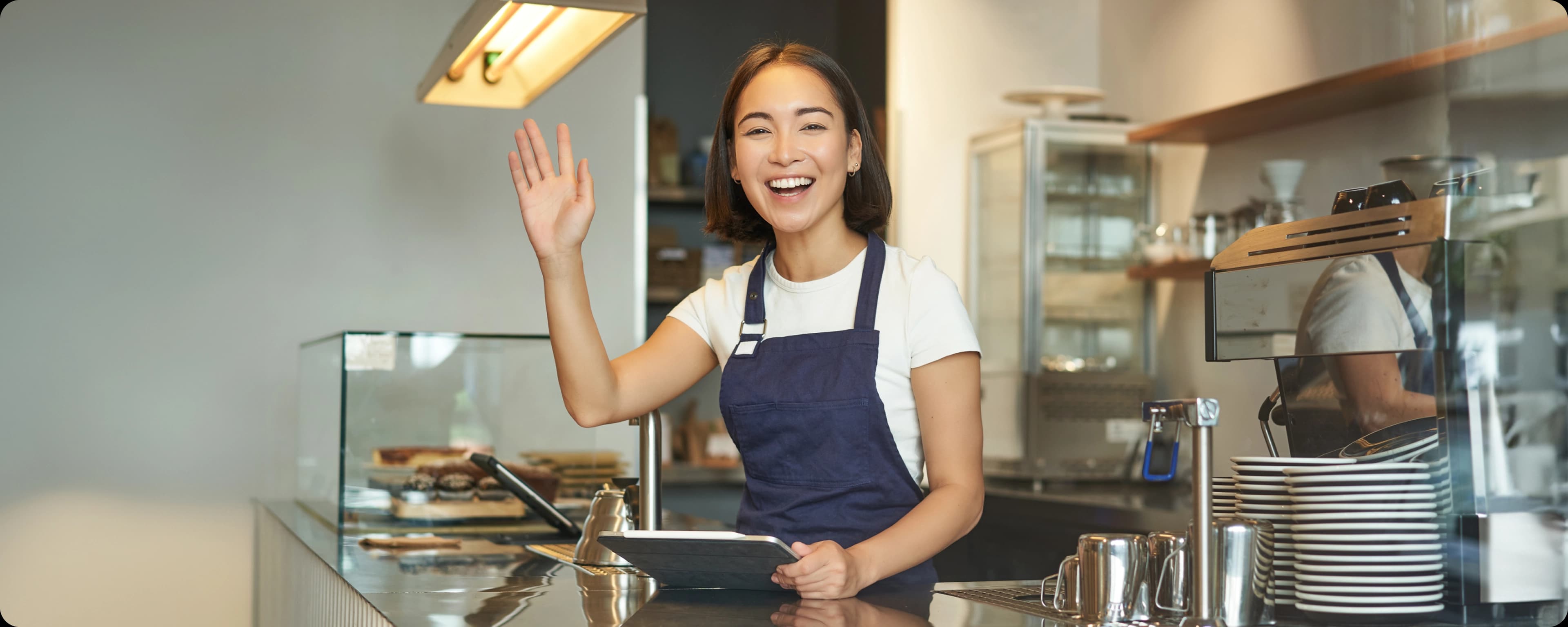 Man in apron using laptop touchpad